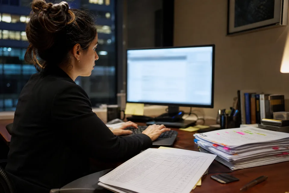 Litigation associate finalizing a brief with a marked-up table of authorities and highlighted case printouts